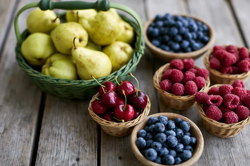 Assorted fresh fruit in woven baskets and small bowls on a wooden table