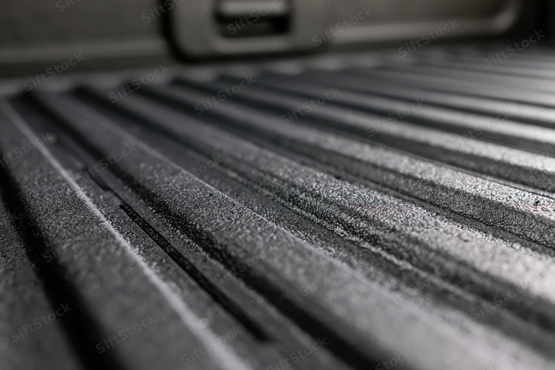 Closeup of ribbed black rubber liner in pickup truck bed