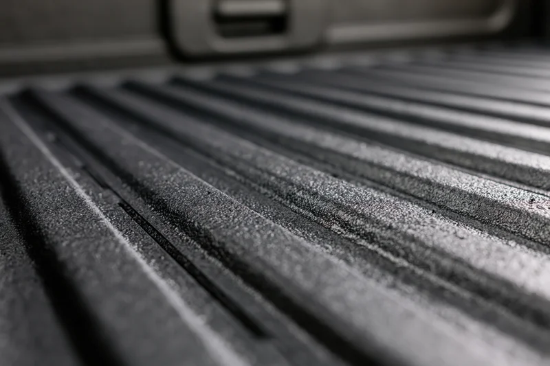 Closeup of ribbed black rubber liner in pickup truck bed