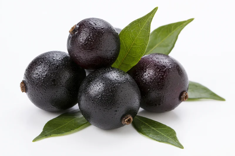 Five fresh acai berries clustered with green leaves on white background