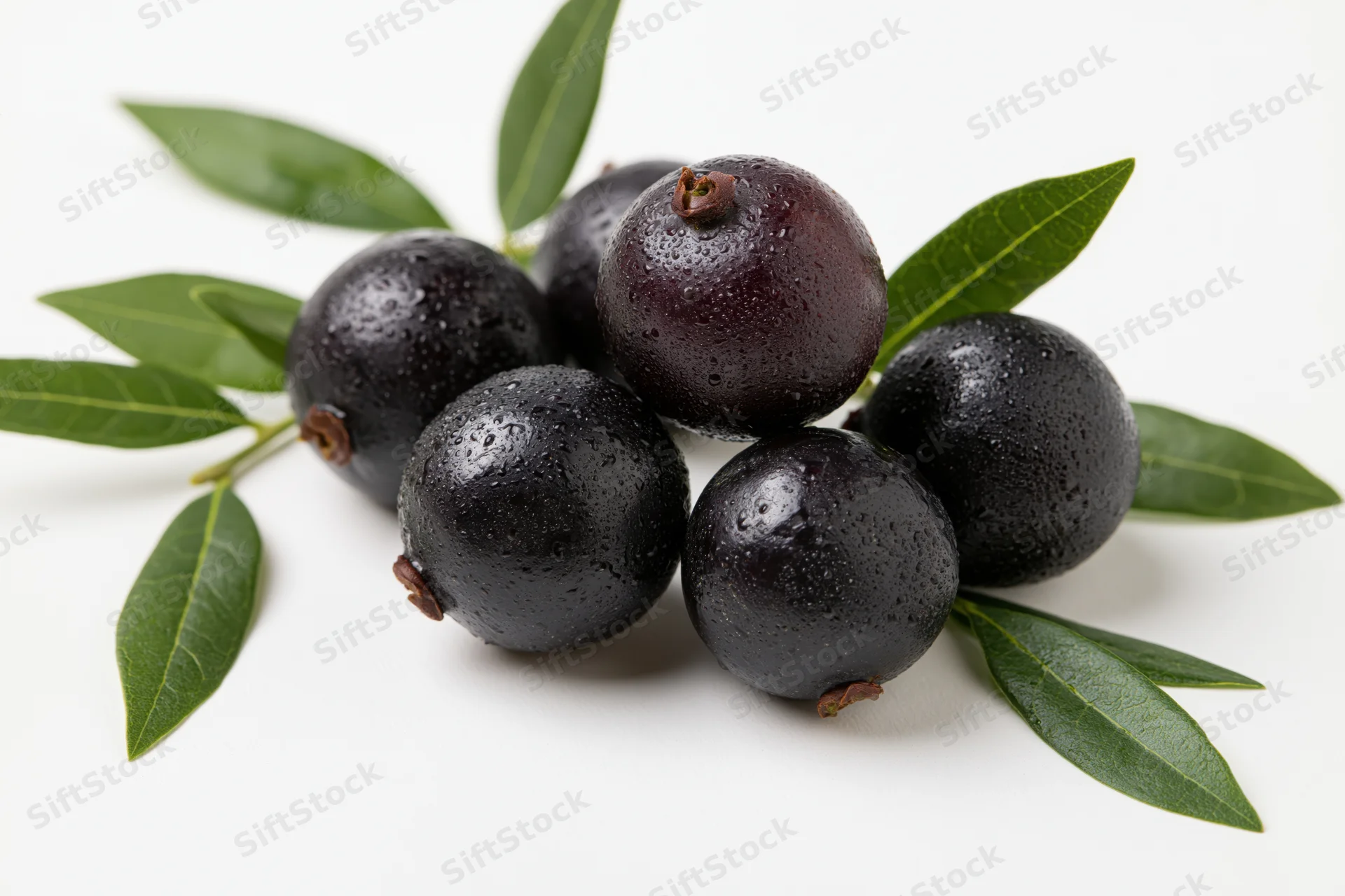 Cluster of fresh acai berries with green leaves on white background