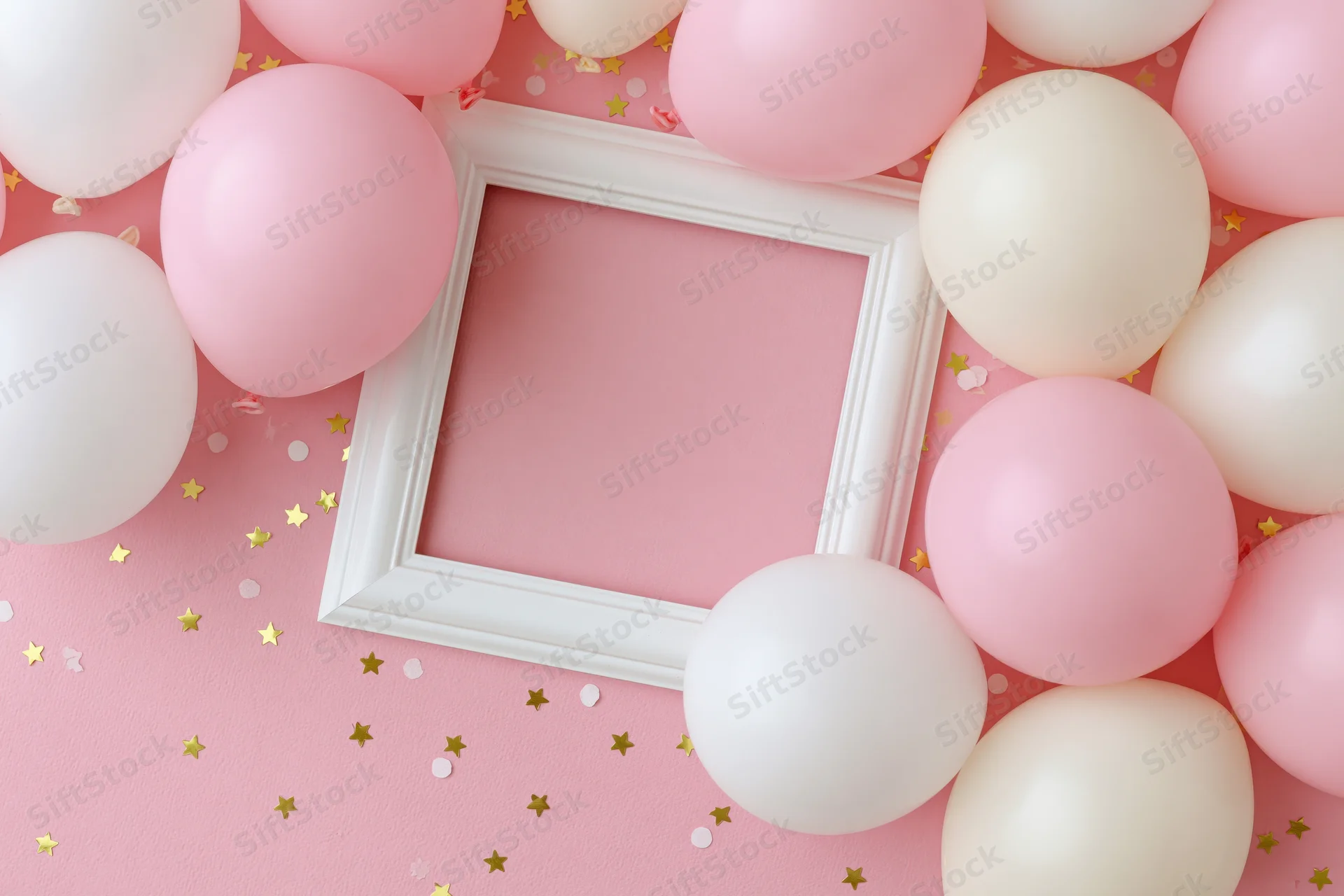 White frame surrounded by pink and white balloons on a pink surface with gold star confetti