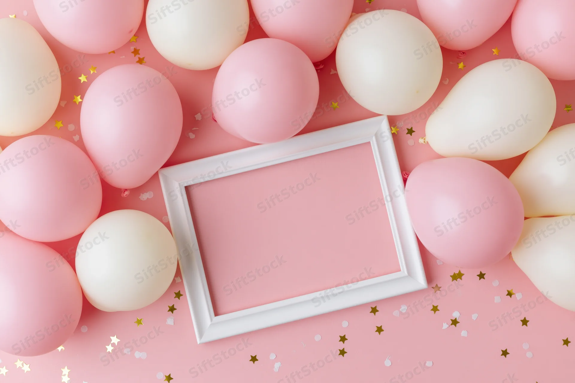 White frame mockup surrounded by pink and white balloons on a pink surface with gold star confetti, flat lay top view