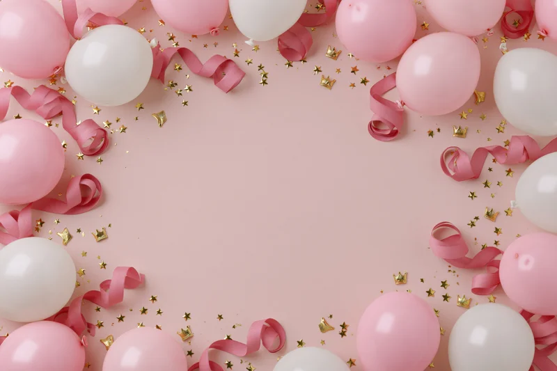 Pink and white balloons with curled ribbon and gold confetti arranged in a frame on a pink background