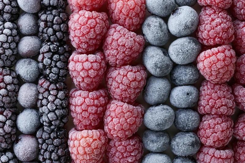 Frozen mixed berries arranged in vertical rows filling the frame