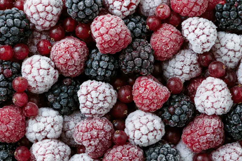 Frozen mixed berries including raspberries blackberries and redcurrants covered in frost