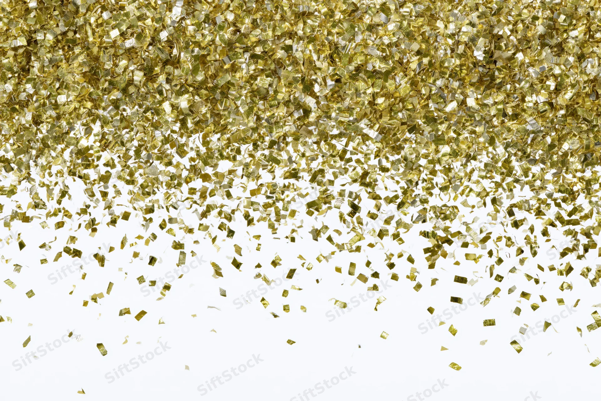 Gold metallic confetti pieces falling and scattering mid-air against white background
