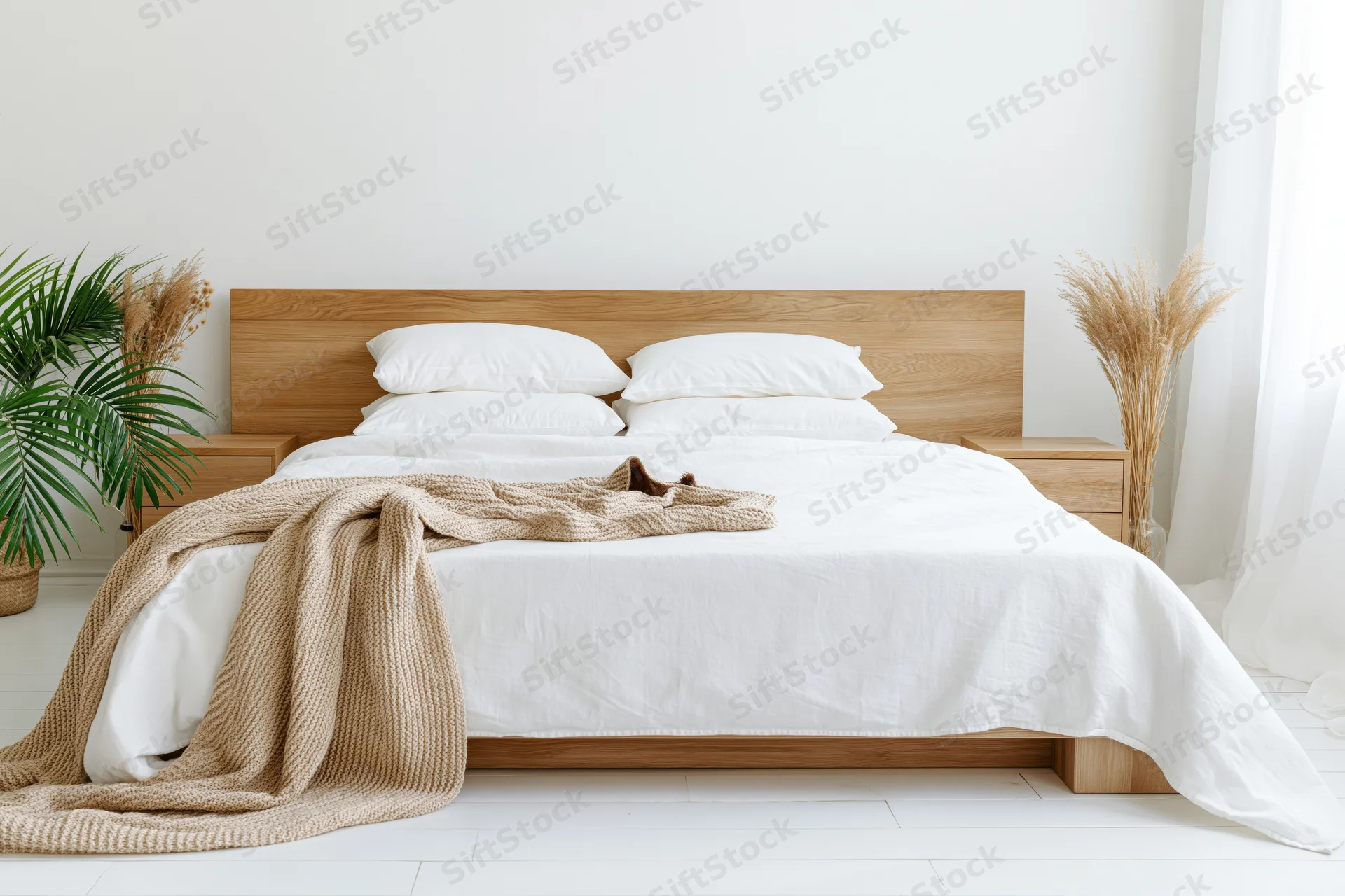Queen bed with white bedding and wooden headboard in minimalist scandinavian bedroom