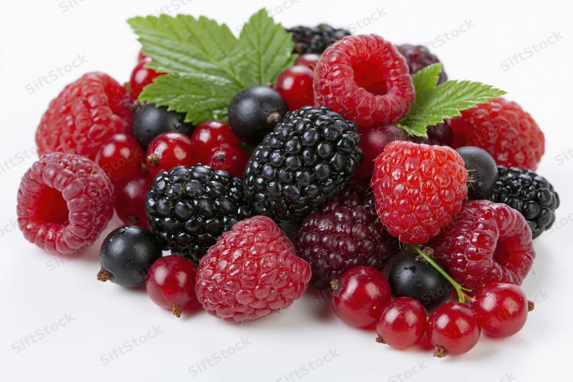 Mixed fresh berries arranged in a loose pile on a clean white background