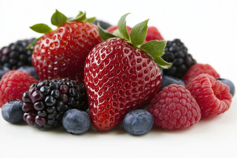 Mixed fresh berries arranged in a cluster on a white background