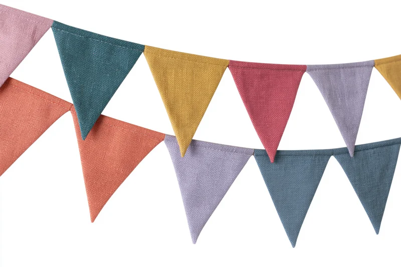Three strands of colorful fabric triangle bunting flags hanging against white background