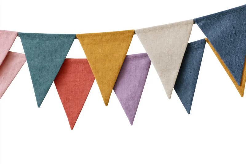 Colorful fabric triangle bunting flags hanging in a row against white background