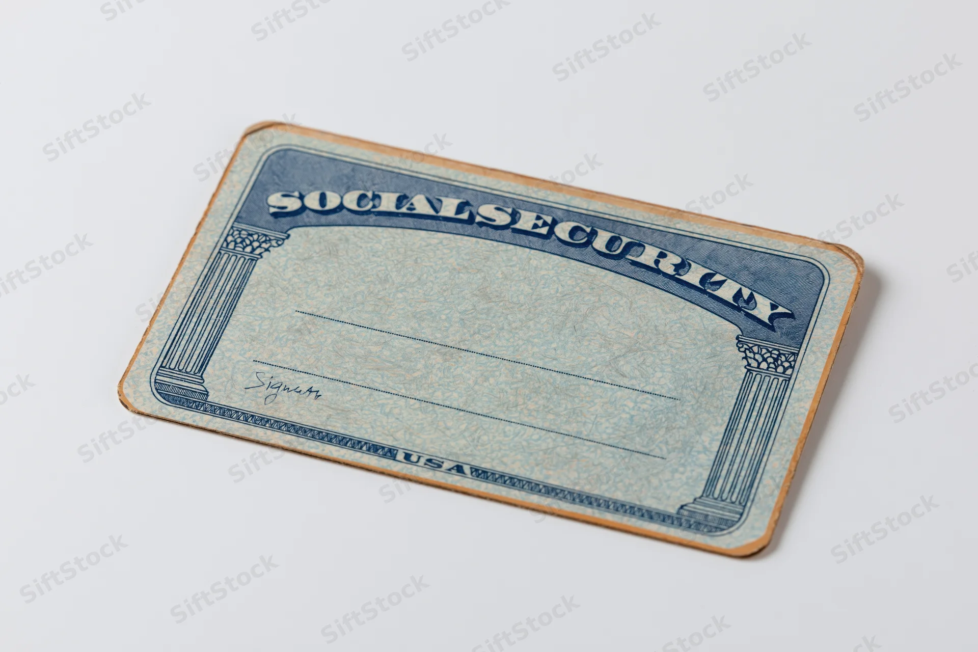 Blank us social security card lying flat on white surface