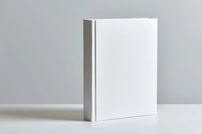Blank white hardcover book standing upright on a white surface