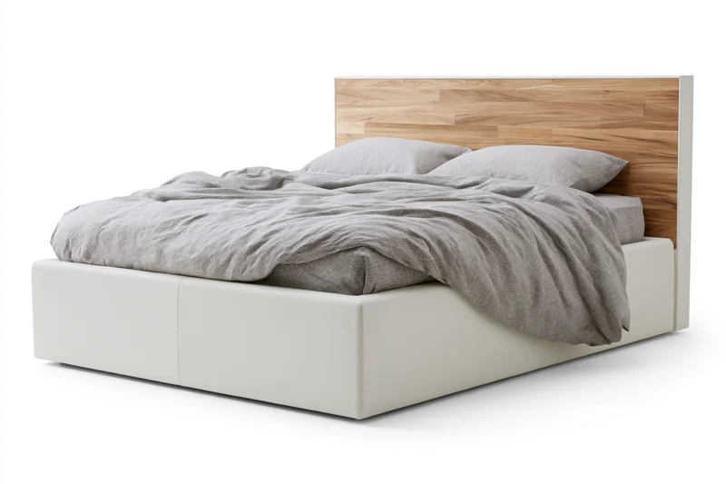 Double bed with white faux-leather frame and wooden headboard, covered in gray duvet and pillows, isolated on white background