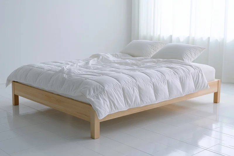 Double bed with light wooden frame and white bedding in minimalist bedroom