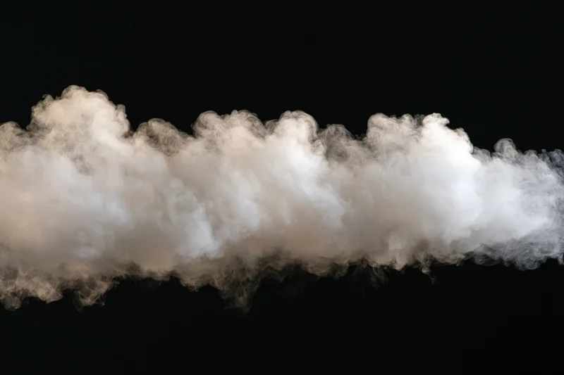 Horizontal wisp of white smoke drifting across black background