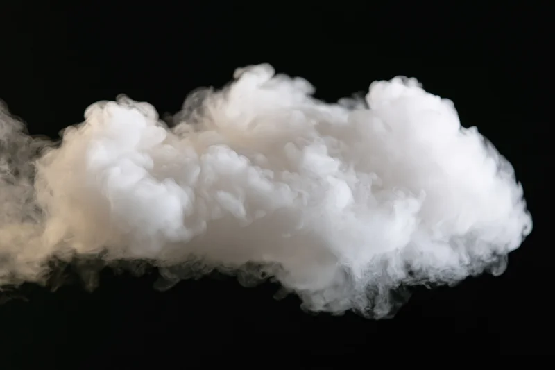 White smoke drifting horizontally across black background