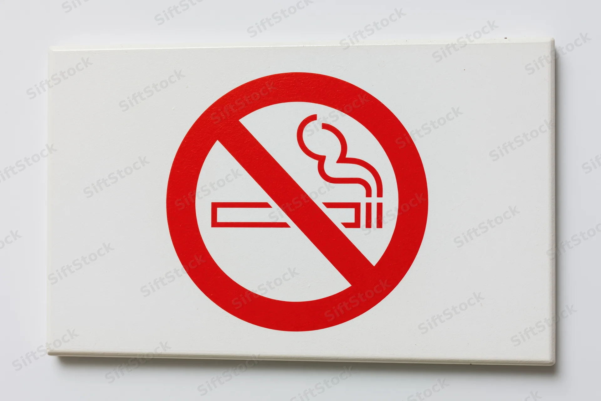 No-smoking prohibition sign with red circle and diagonal slash on white background