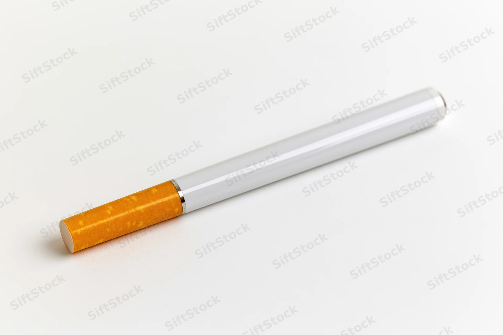 Electronic cigarette with white body and orange filter lying on white surface