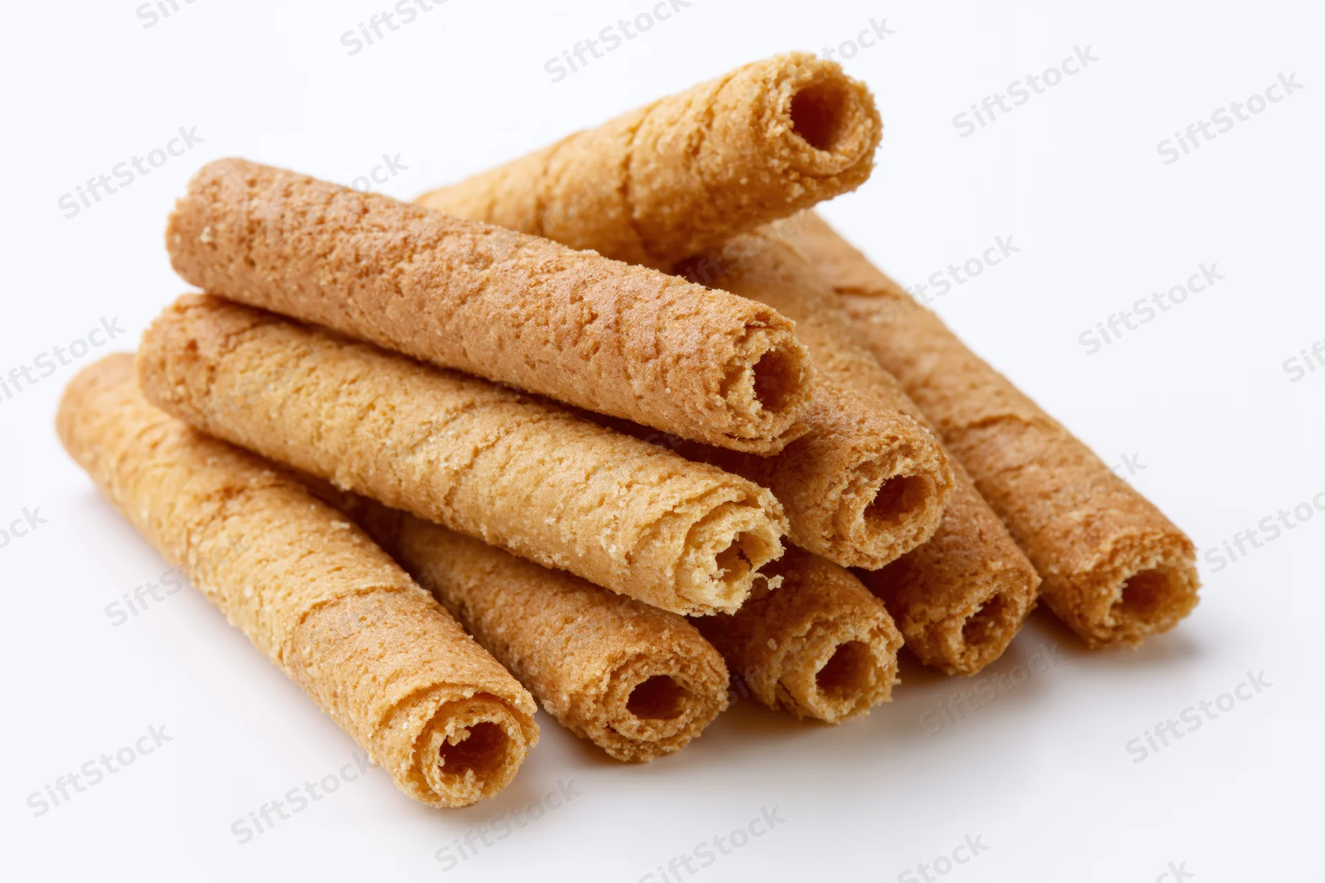 Stack of crispy rolled wafer biscuits on white background