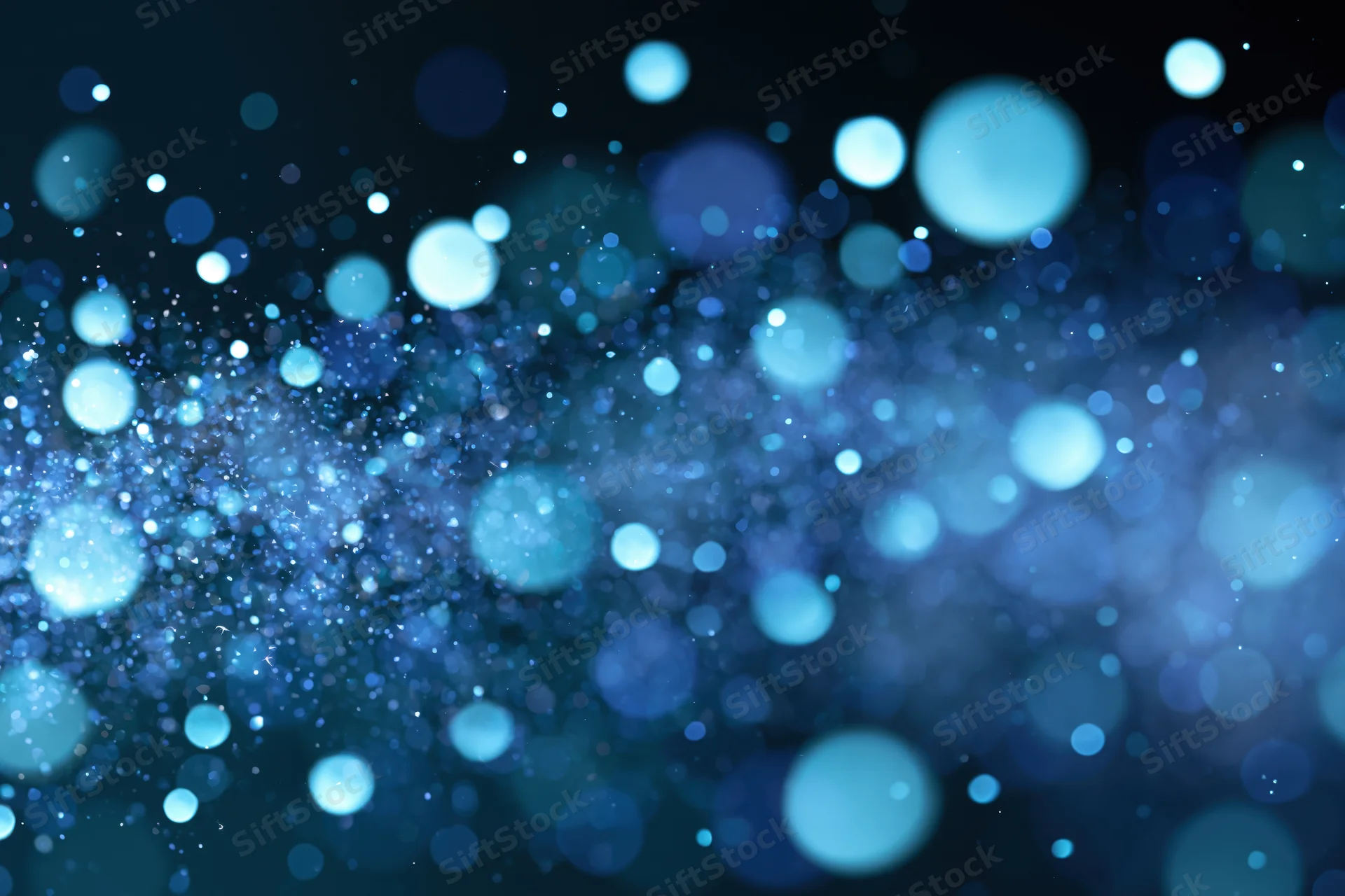 Abstract bokeh background with scattered out-of-focus blue light circles on dark surface