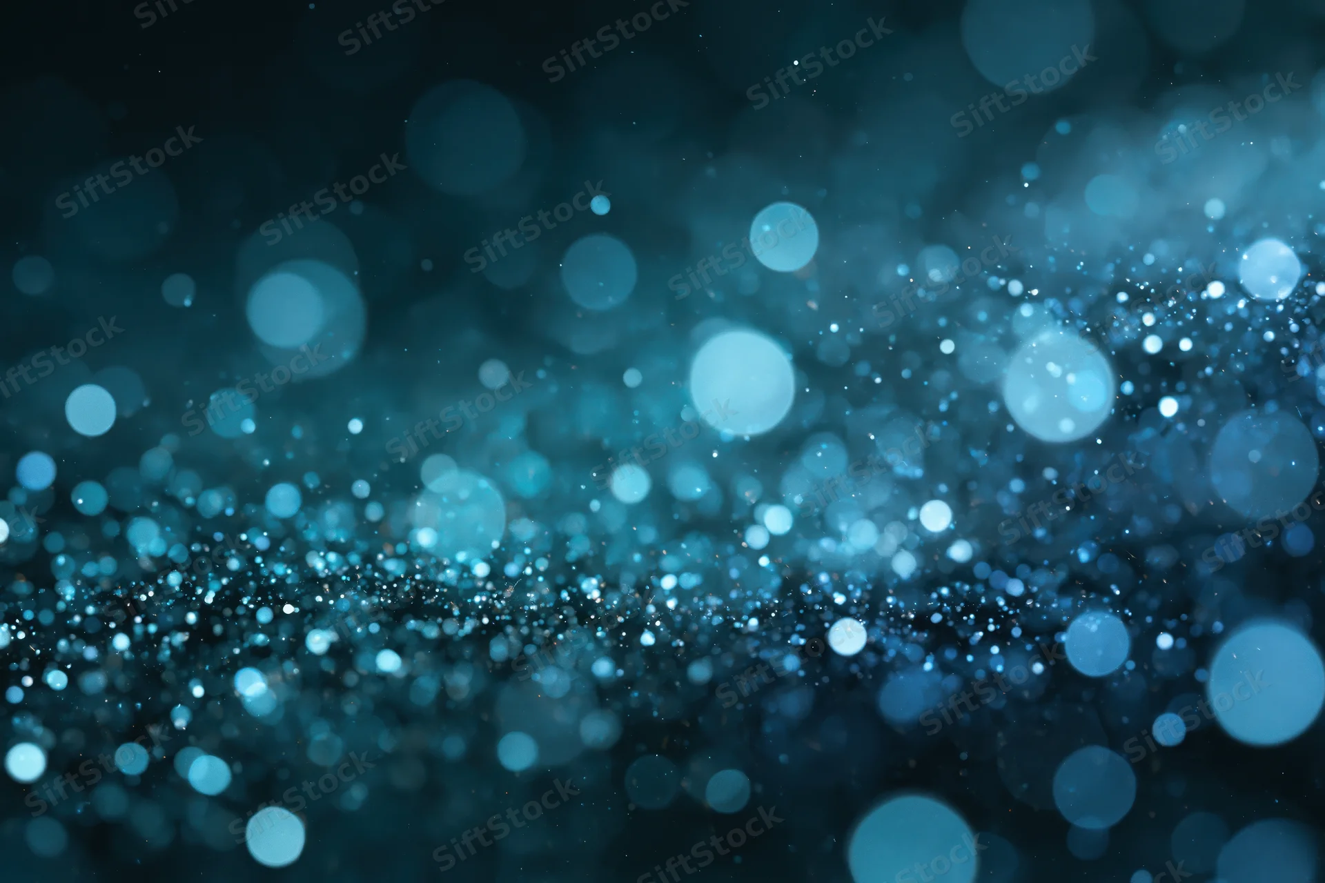 Abstract bokeh background with scattered out-of-focus blue light circles and sparkling particles