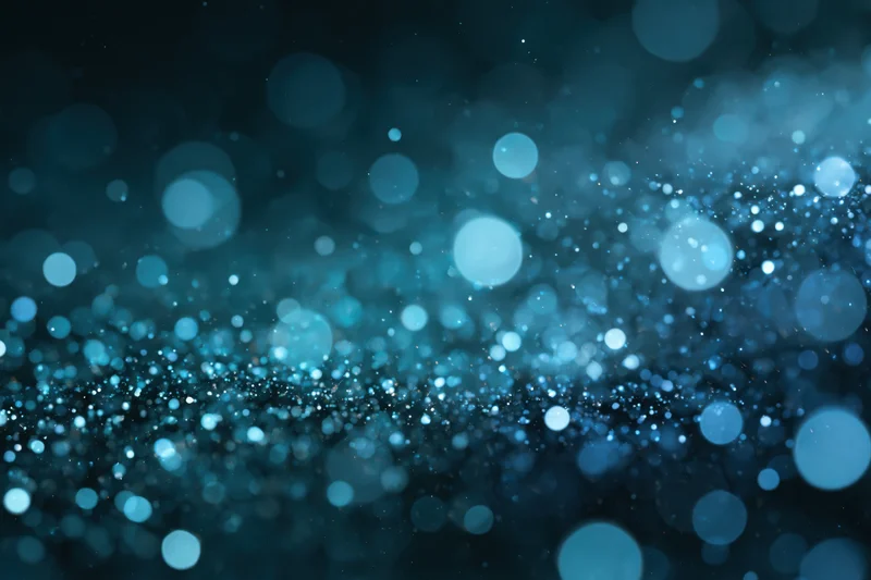 Abstract bokeh background with scattered out-of-focus blue light circles and sparkling particles