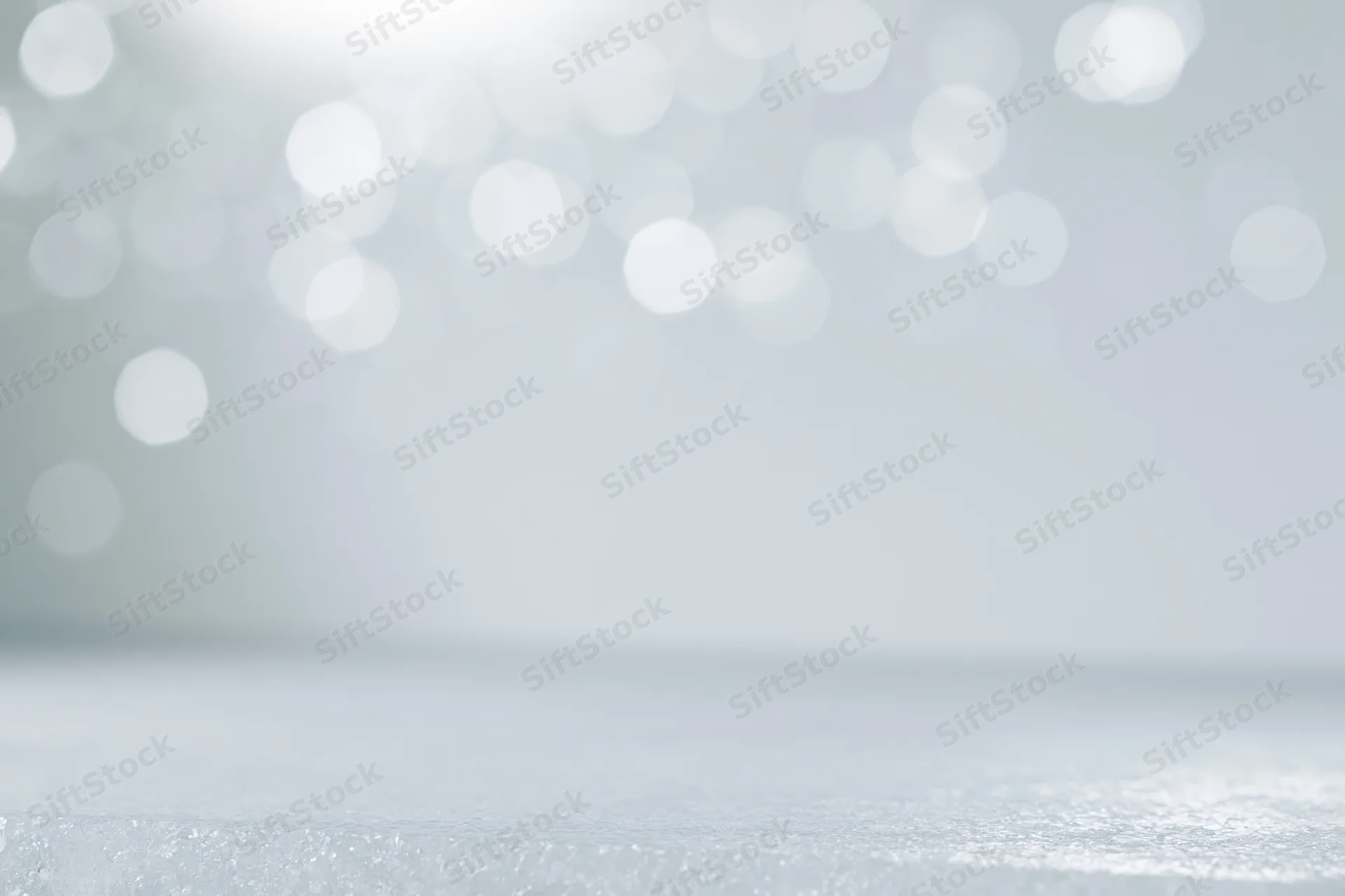 Abstract white bokeh background with soft out-of-focus lights and glittery surface