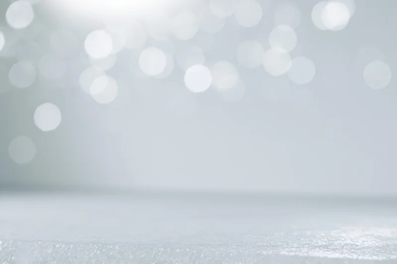 Abstract white bokeh background with soft out-of-focus lights and glittery surface