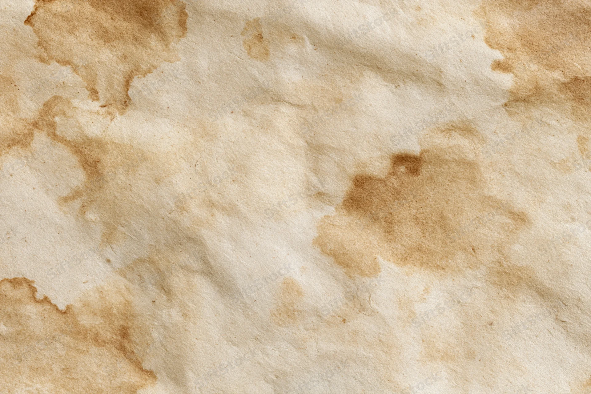 Aged paper surface with uneven brown water stains and creases
