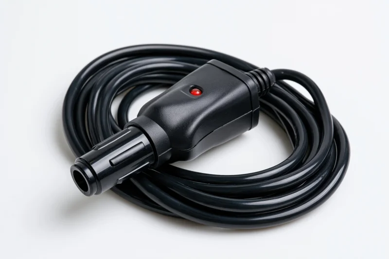 Coiled black car cigarette lighter adapter plug with red indicator light on white background