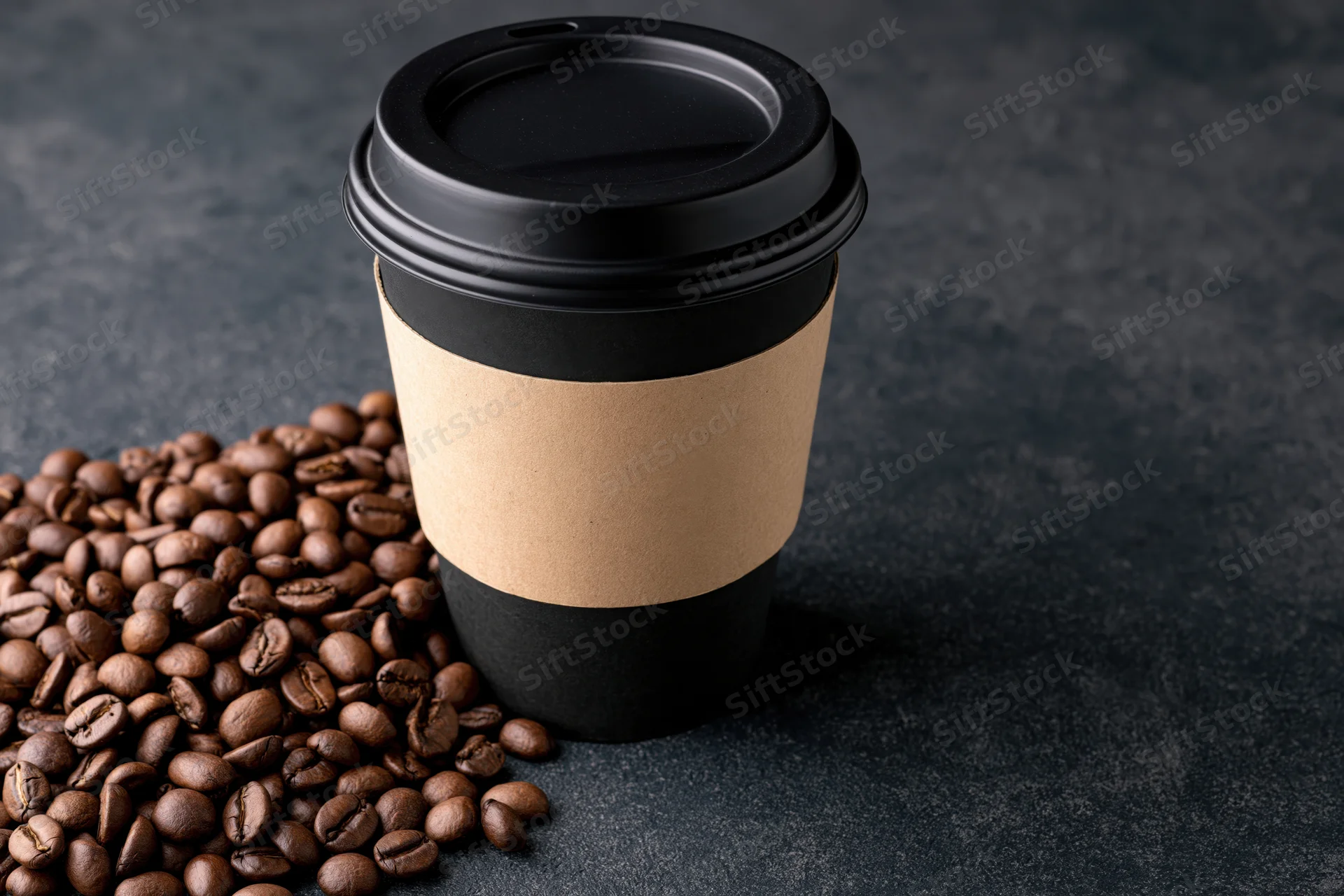 Black paper takeaway coffee cup with kraft sleeve and roasted coffee beans on dark textured surface