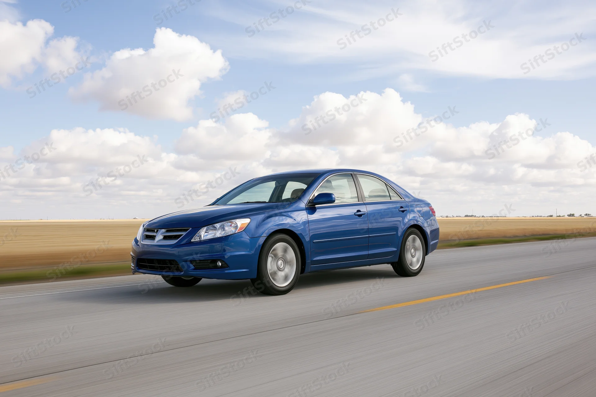 Blue midsize sedan driving on a two-lane asphalt highway under a cloudy sky