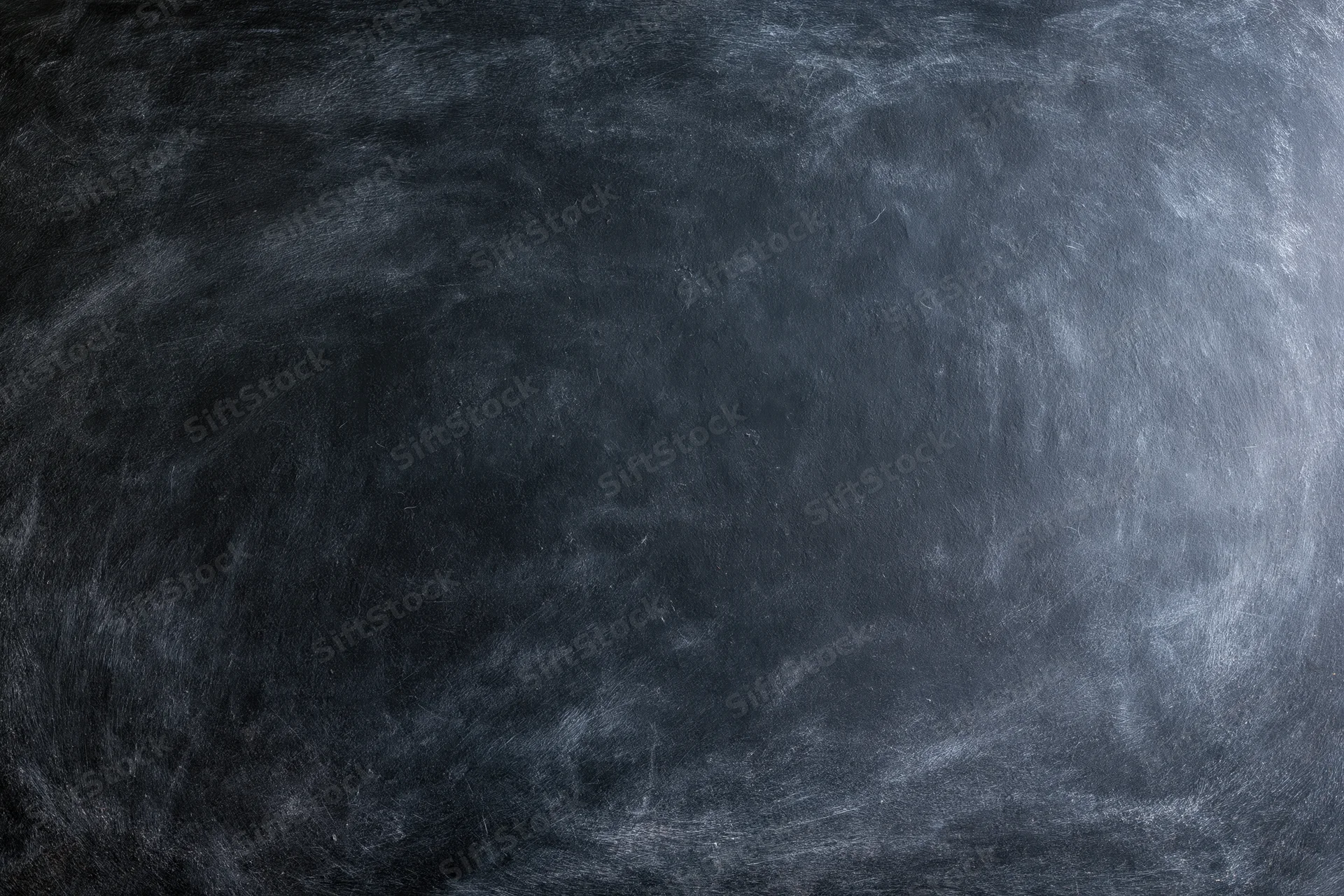 Close-up of a blank black chalkboard surface with smudged texture filling the frame