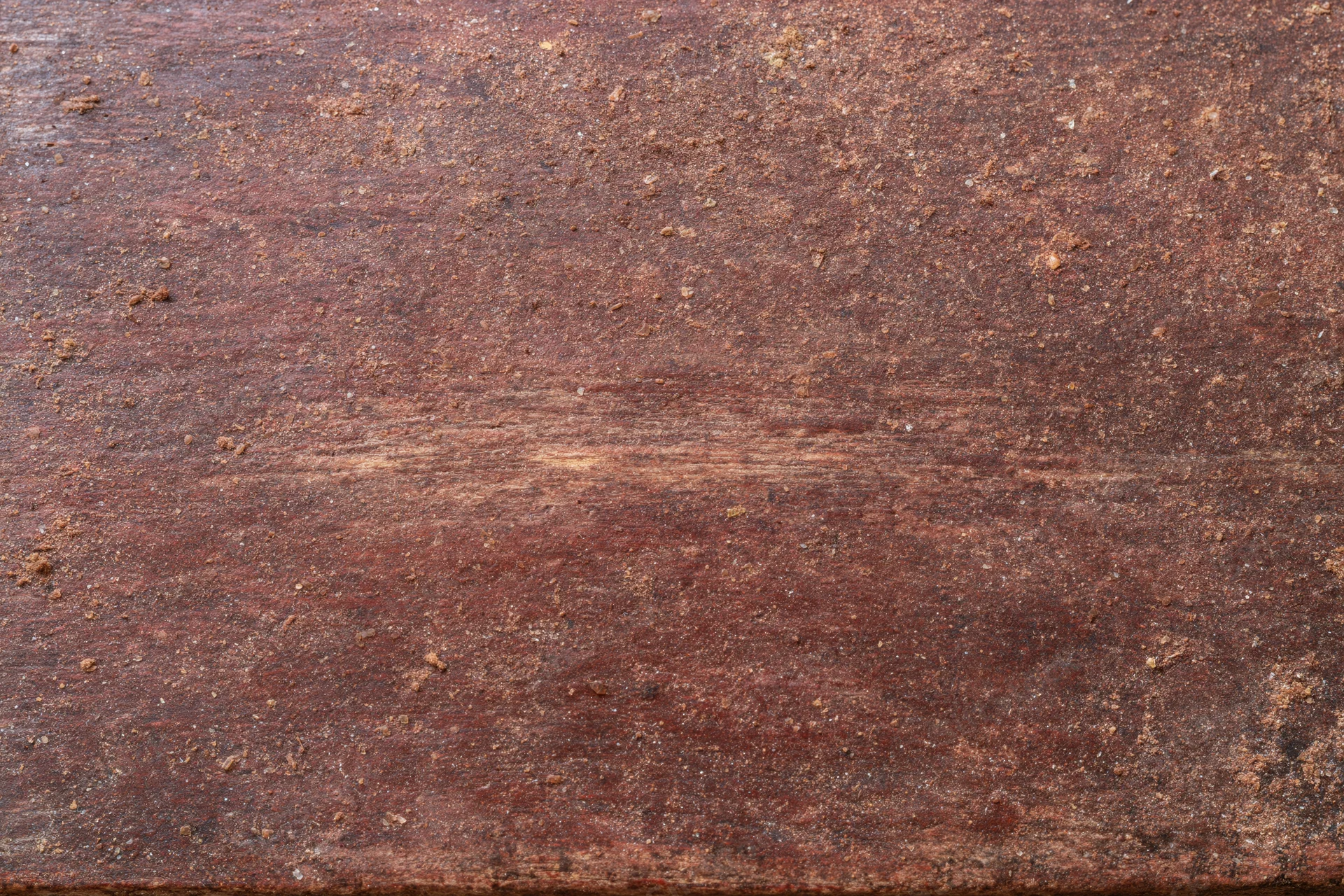 Close-up of aged dark brown wooden surface with visible grain and texture