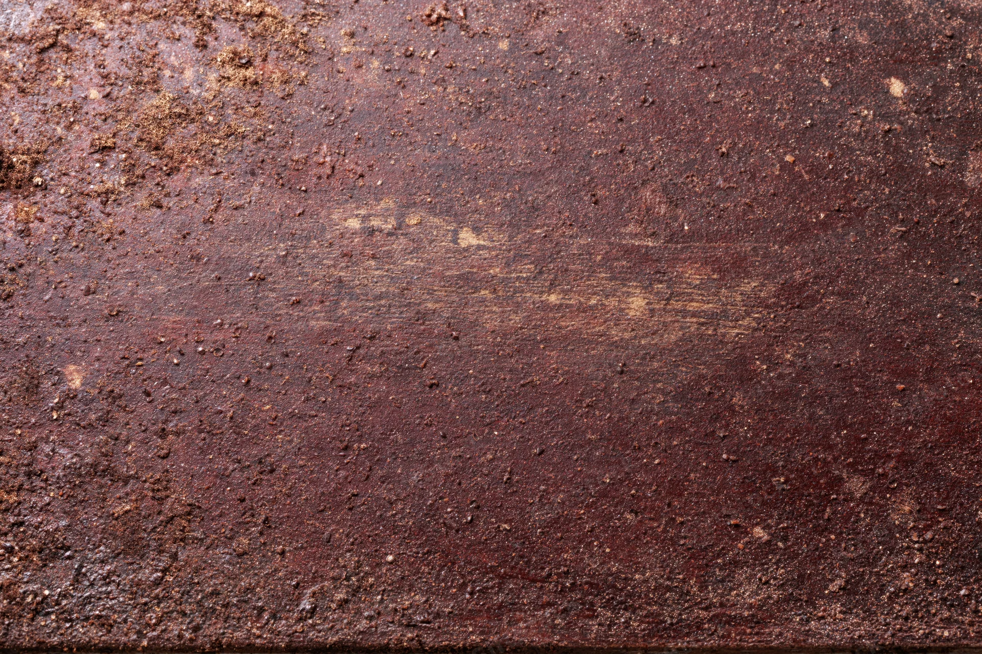 Close-up of a rusted metal surface showing weathered texture and corrosion