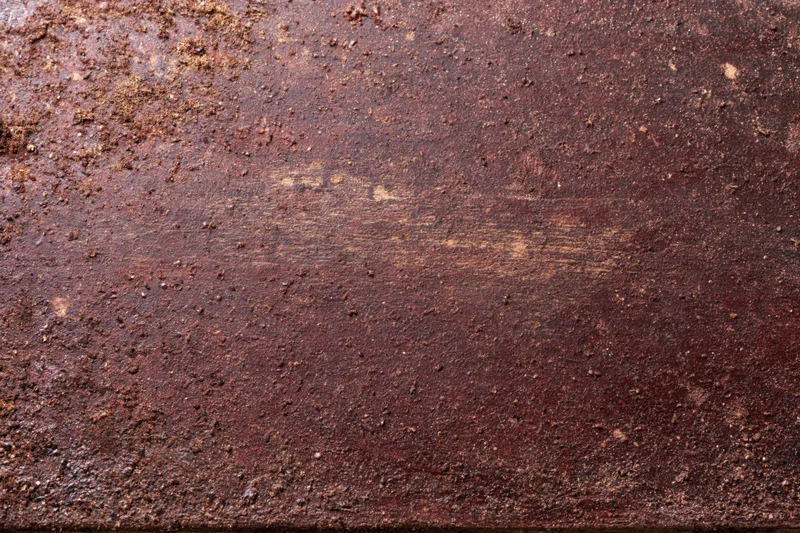 Close-up of a rusted metal surface showing weathered texture and corrosion