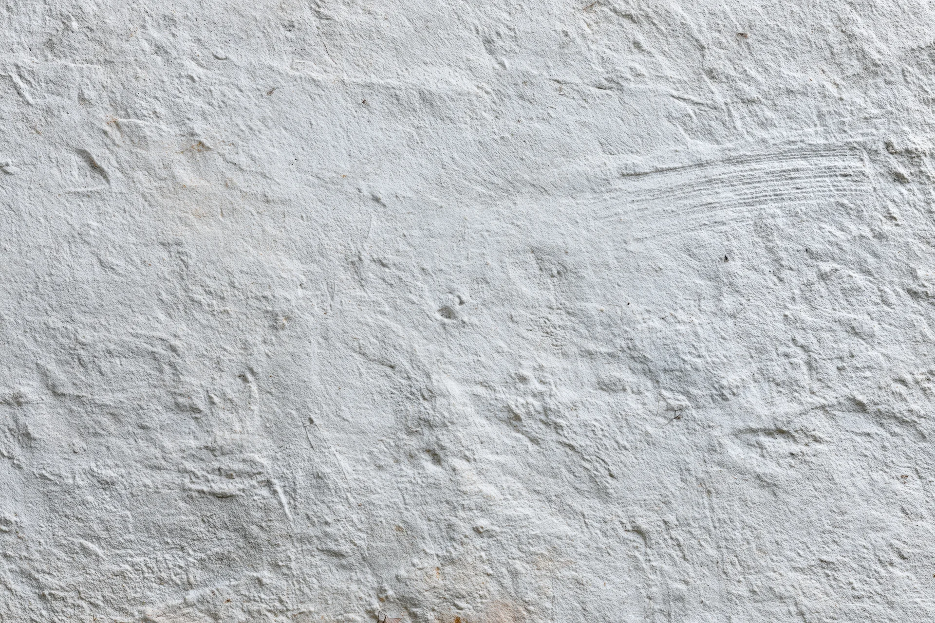 Close-up of a rough concrete wall surface with visible texture and imperfections