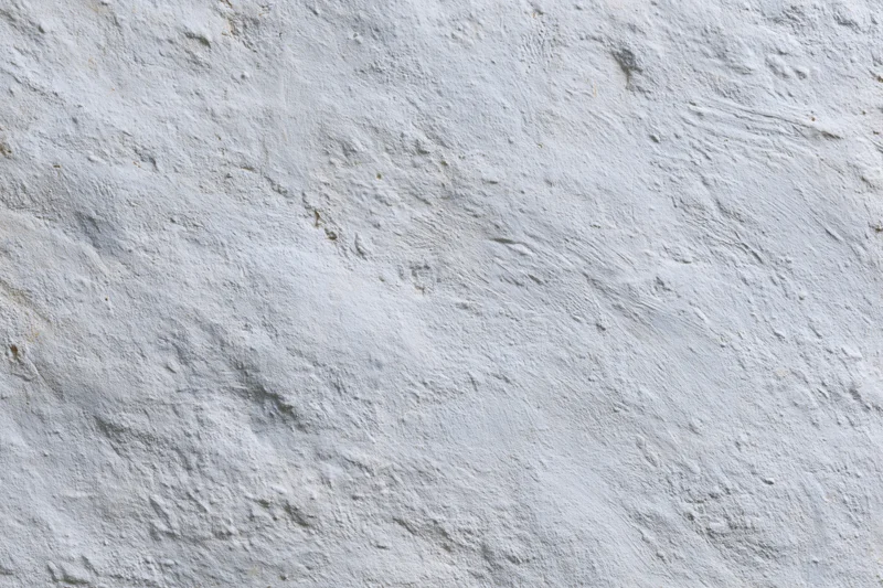 Close-up of a rough concrete wall surface with visible texture and imperfections