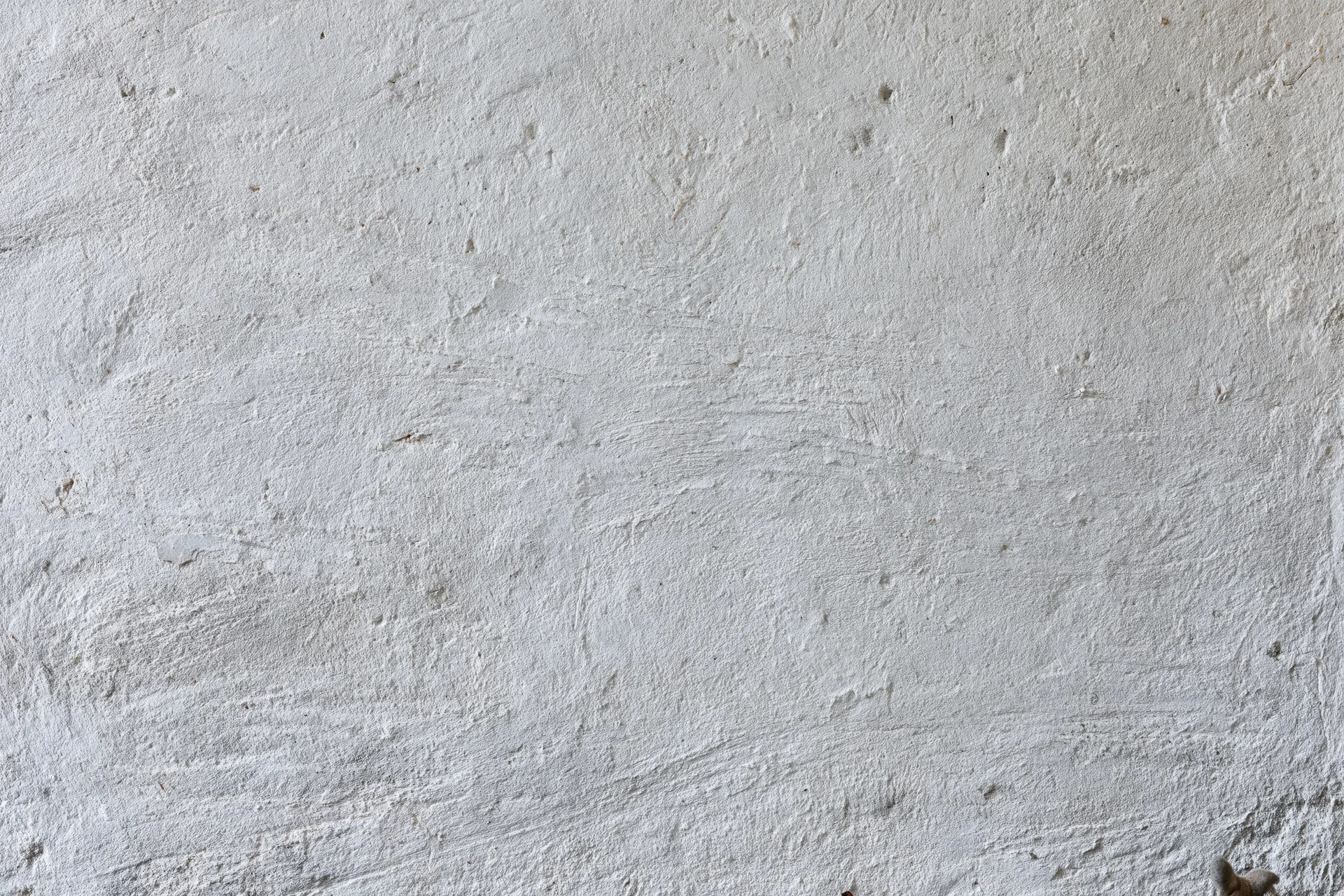 Close-up of a rough concrete wall surface with visible texture and imperfections