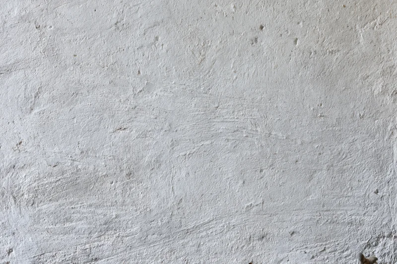 Close-up of a rough concrete wall surface with visible texture and imperfections