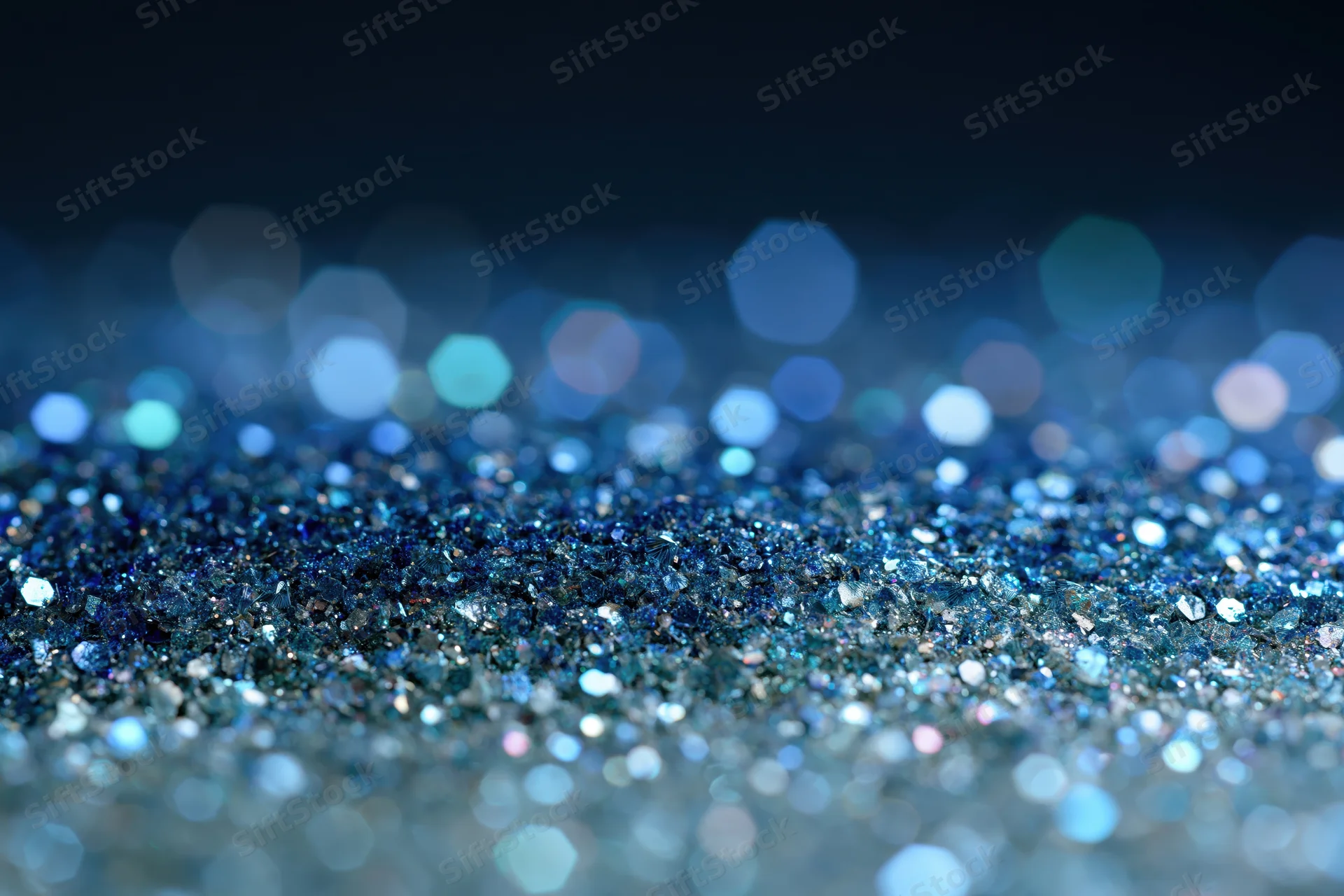 Close-up of blue glitter surface with scattered light reflections and bokeh effect