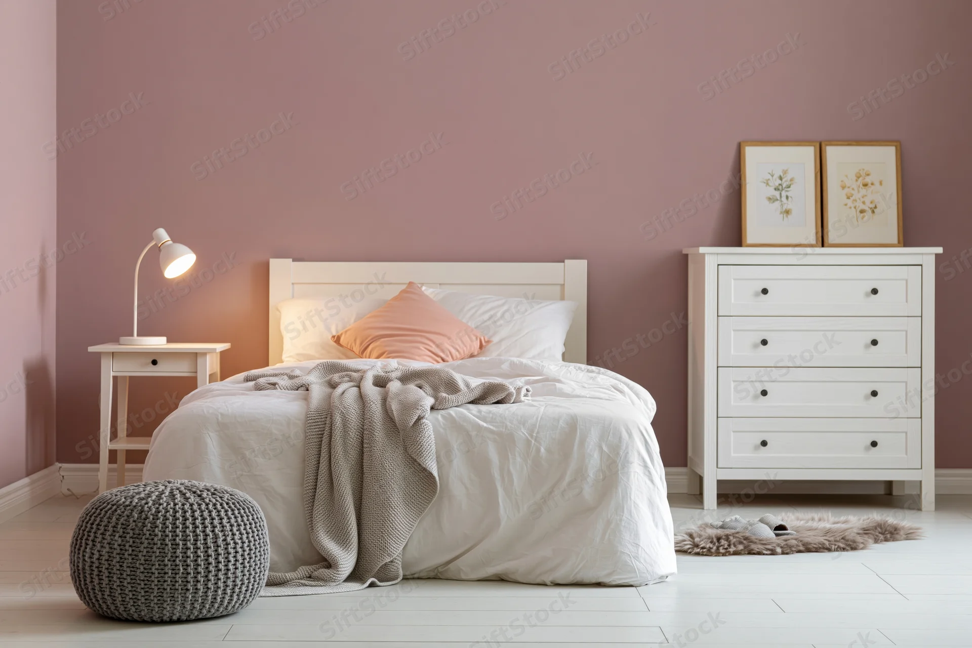 Cozy bedroom with white bed and pink walls featuring nightstand, dresser, and knitted pouf