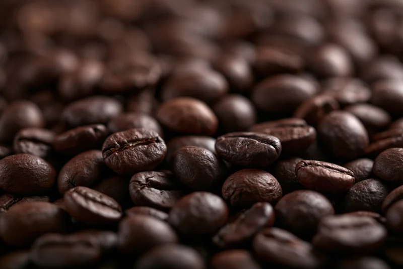 Dark roasted coffee beans in closeup filling the frame