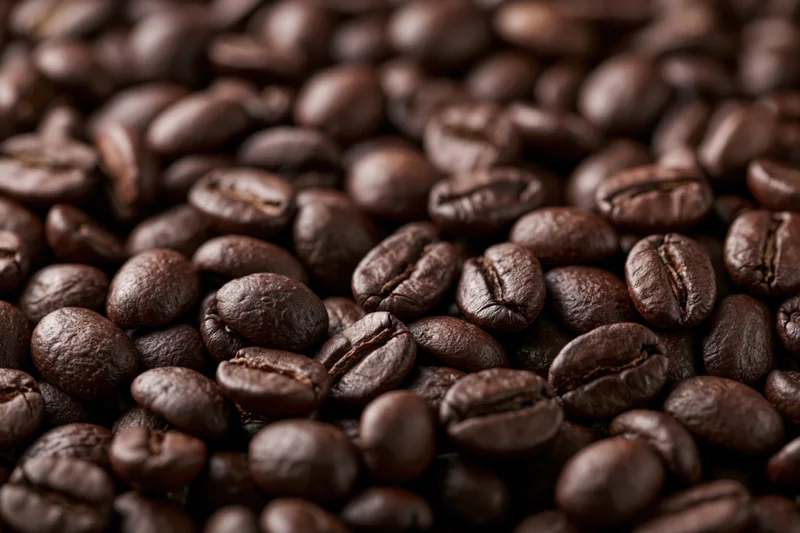 Closeup of dark roasted coffee beans filling the frame