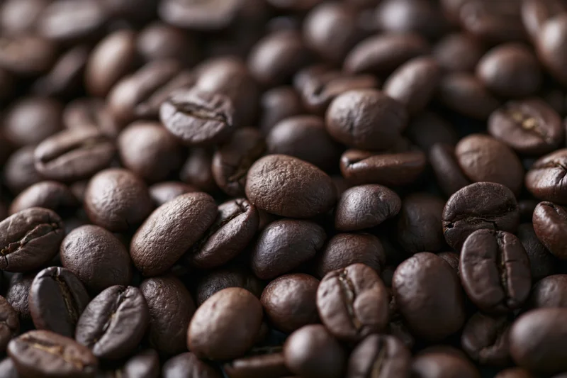 Dark roasted coffee beans in closeup filling the frame