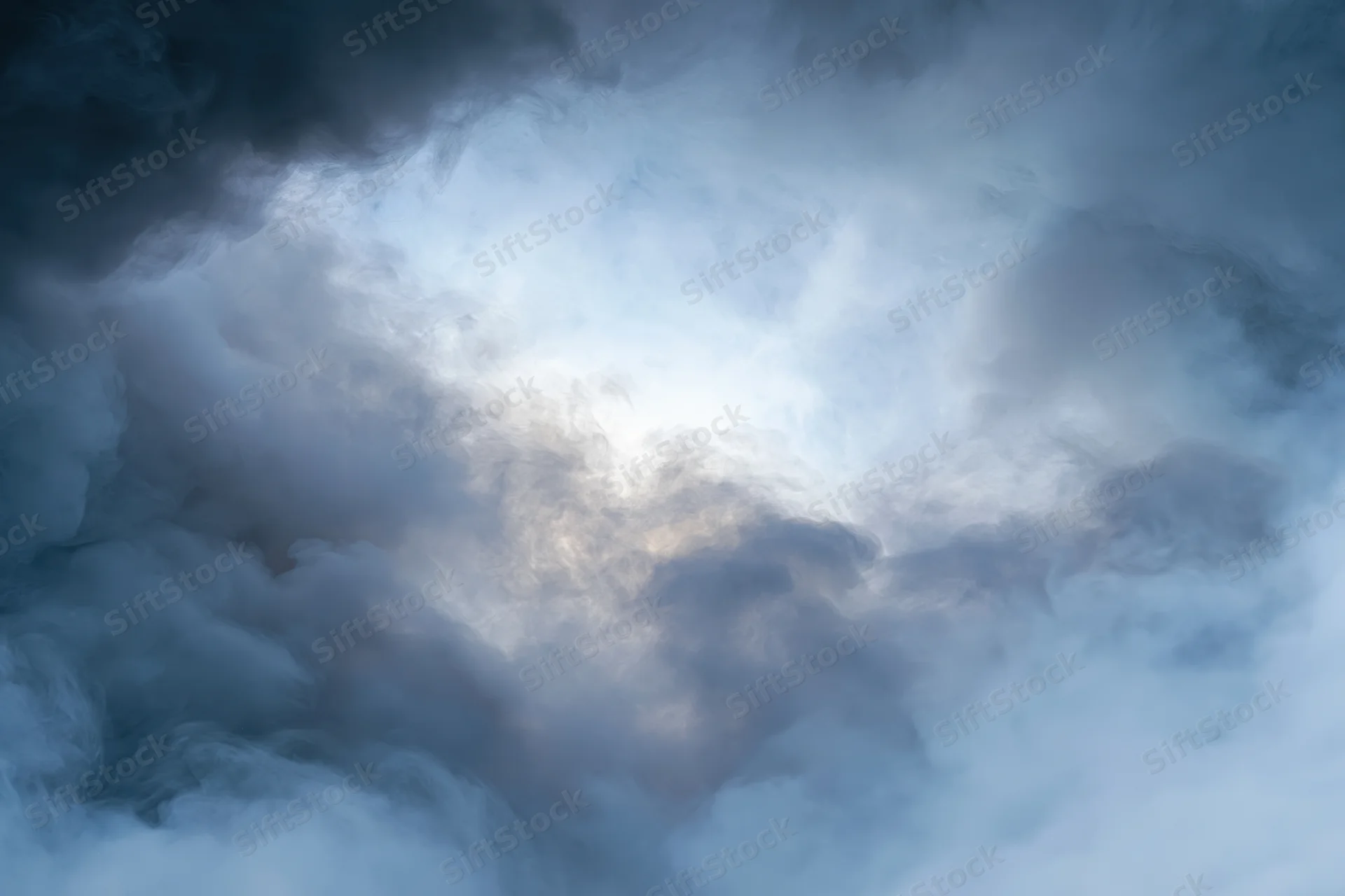 Dense billowing smoke filling the frame with swirling gray and white vapor against a dark atmospheric background