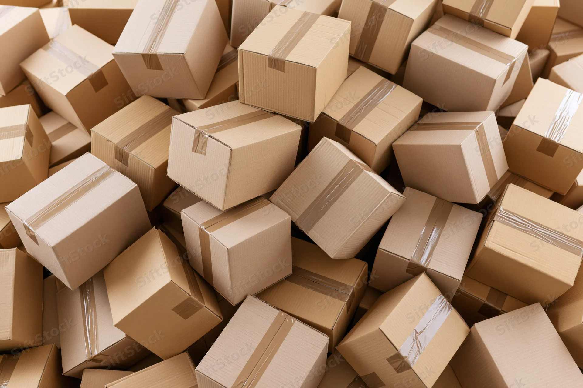 Cardboard boxes piled and scattered in a warehouse storage area
