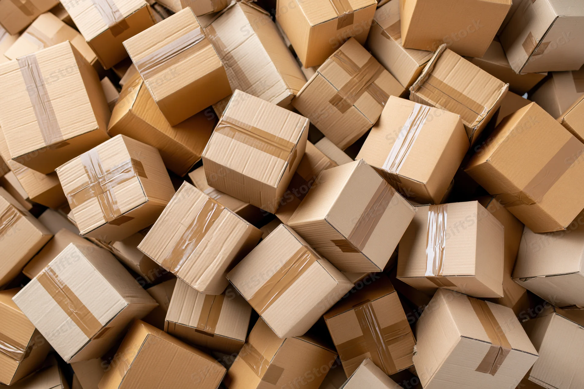 Cardboard boxes piled and scattered in a warehouse storage area